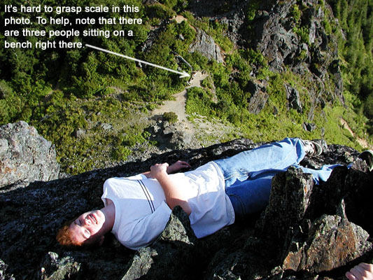 Dylan laying on a cliff.
